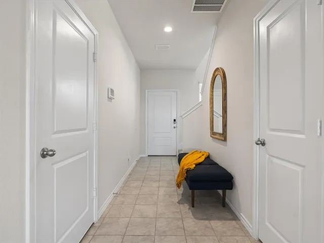 a bedroom with a bed and a lamp