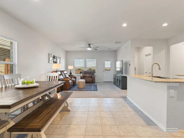 a large kitchen with stainless steel appliances lots of counter top space and a sink