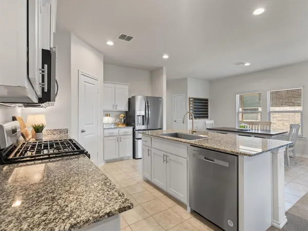 a kitchen with a sink stove and refrigerator