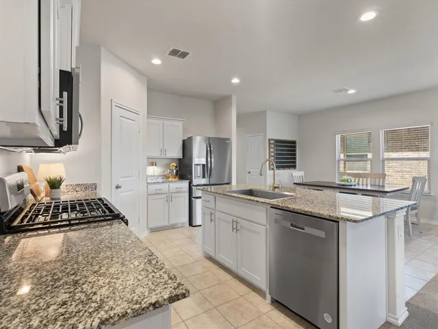 a kitchen with a sink stove and refrigerator