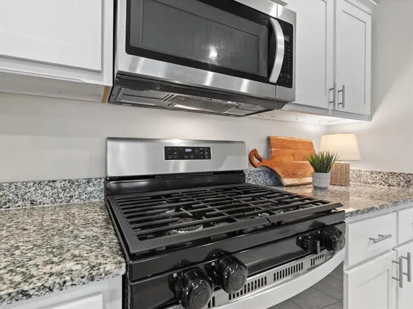 a stove top oven sitting inside of a kitchen