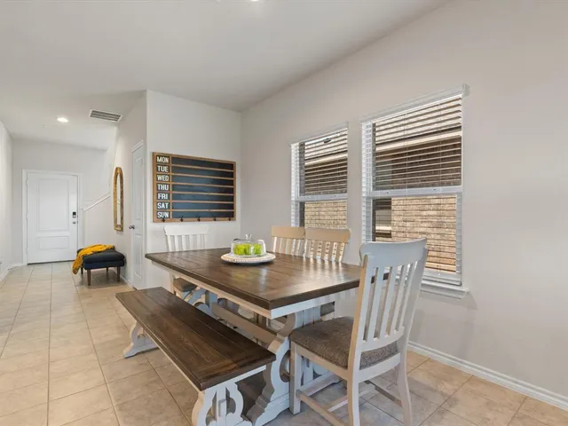 a view of a dining room with furniture and window
