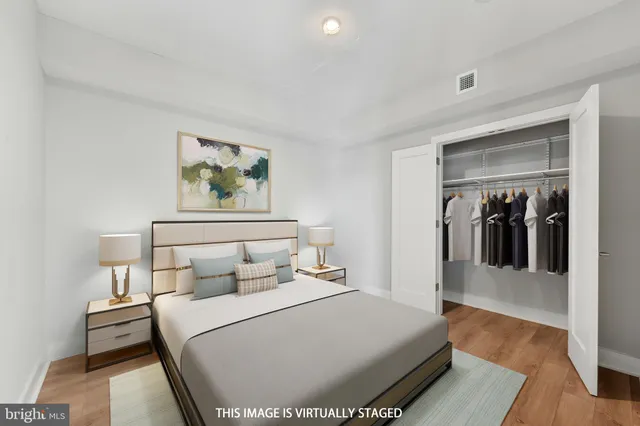 a bedroom with a bed and a painting on the wall