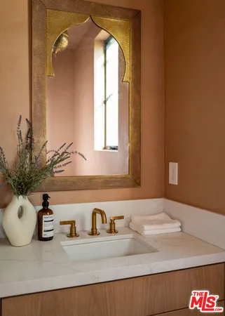 a bathroom with a granite countertop sink and a mirror