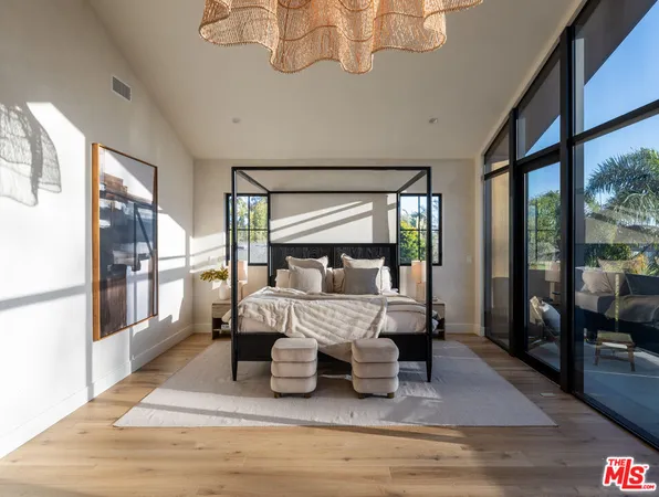 a bedroom with furniture and a large window