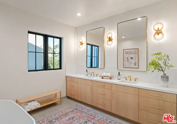 a bathroom with a double vanity sink and a mirror