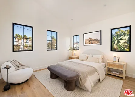 a bedroom with a bed and a couch