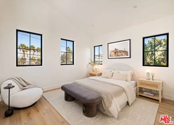 a bedroom with a bed and a couch