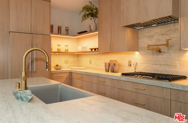 a kitchen with a sink a stove and cabinets