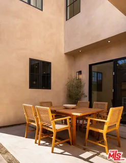 a patio with table and chairs