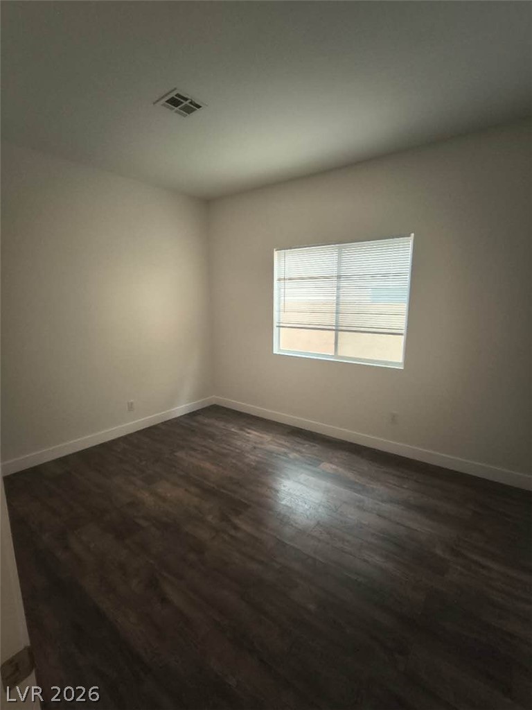 9725 Pima Point Avenue Las Vegas, NV 89147 - Photo 25 of 35 Sun-filled room boasts resilient wood flooring, creating a warm and inviting atmosphere.