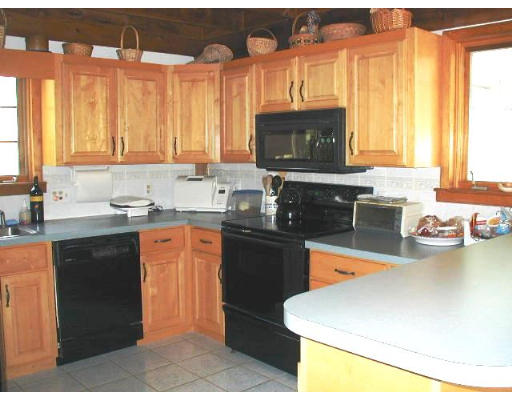 140 Rattlesnake Hill Road Andover, MA 01810 - Photo 5 of 11 a kitchen with a sink a stove and a microwave