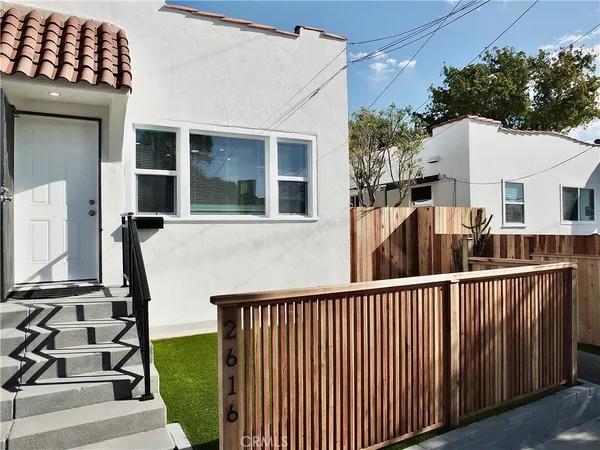 a potted plant sitting in front of a house