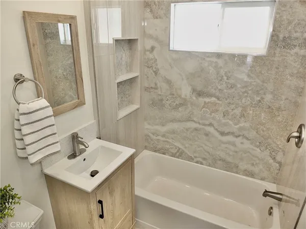 a bathroom with a sink a mirror and a bathtub