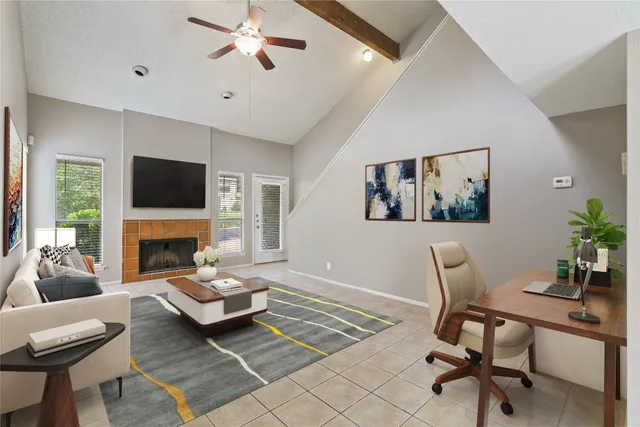 a living room with furniture a fireplace and a flat screen tv