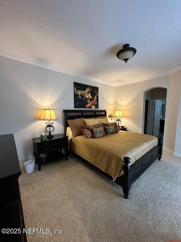 101 Hedgewood Drive St. Augustine, FL 32092 - Photo 9 of 27 a bedroom with a bed and a lamp on table