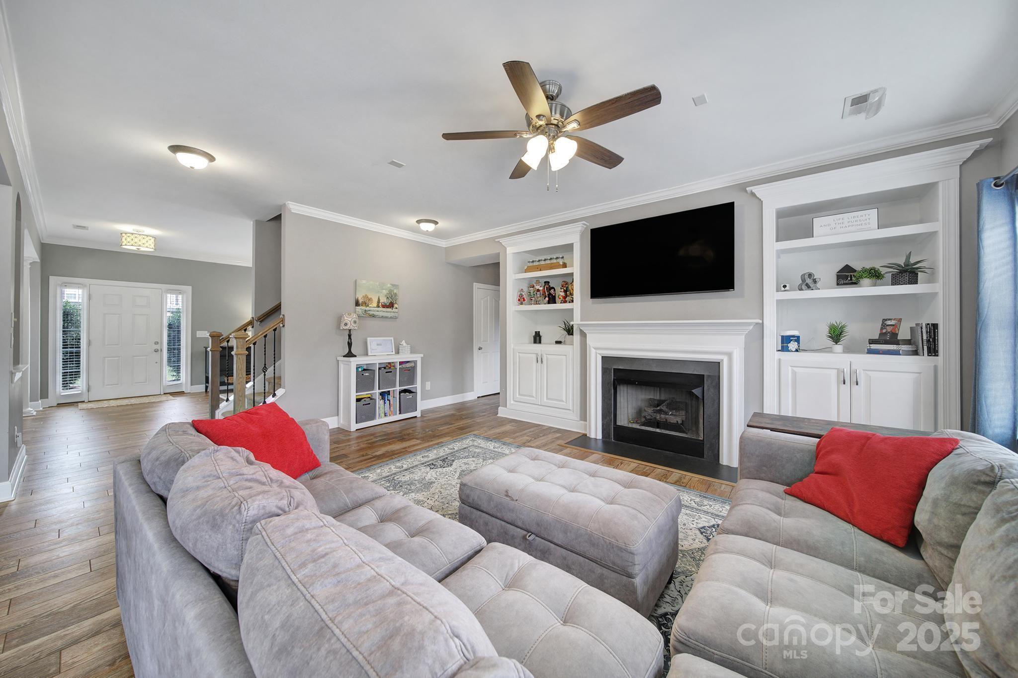1002 Dataw Lane Indian Trail, NC 28079 - Photo 11 of 36 a living room with furniture or flat screen tv and a fireplace