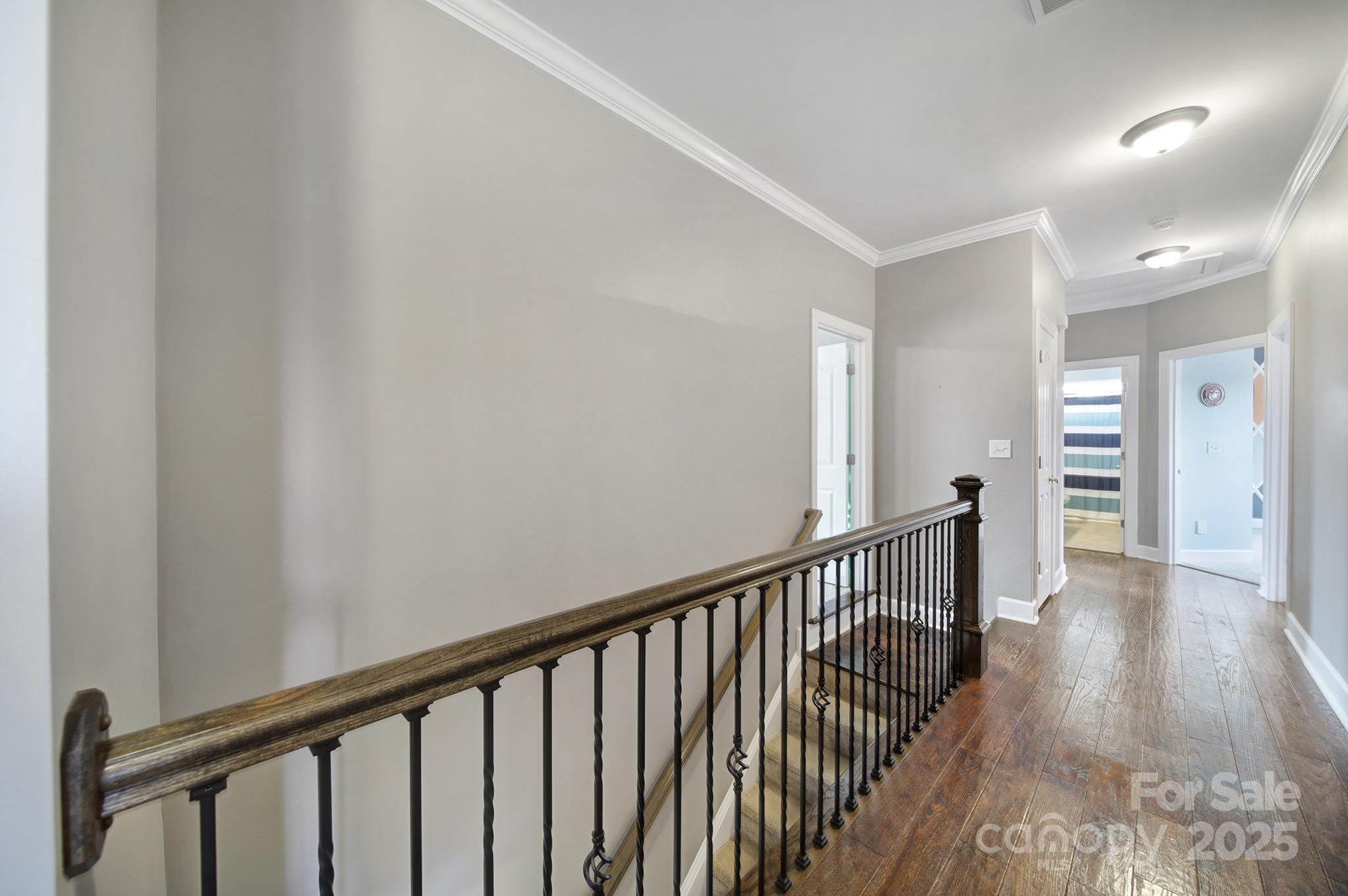 1002 Dataw Lane Indian Trail, NC 28079 - Photo 16 of 36 a view of a hallway with wooden floor and staircase