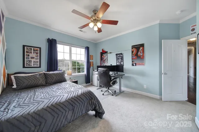 a bedroom with a bed couch and window