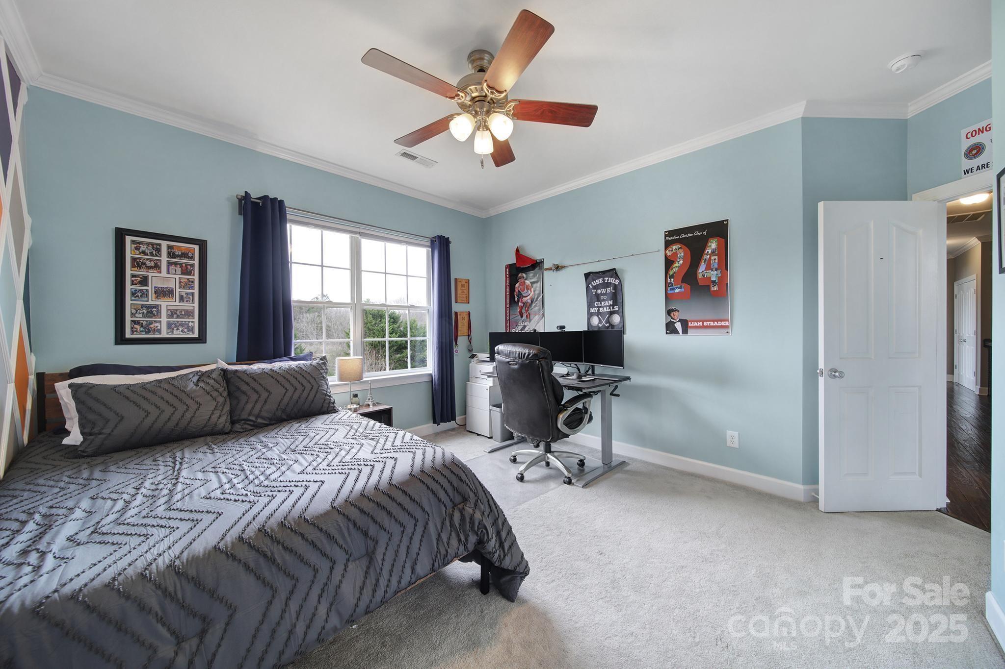 1002 Dataw Lane Indian Trail, NC 28079 - Photo 19 of 36 a bedroom with a bed and a chandelier