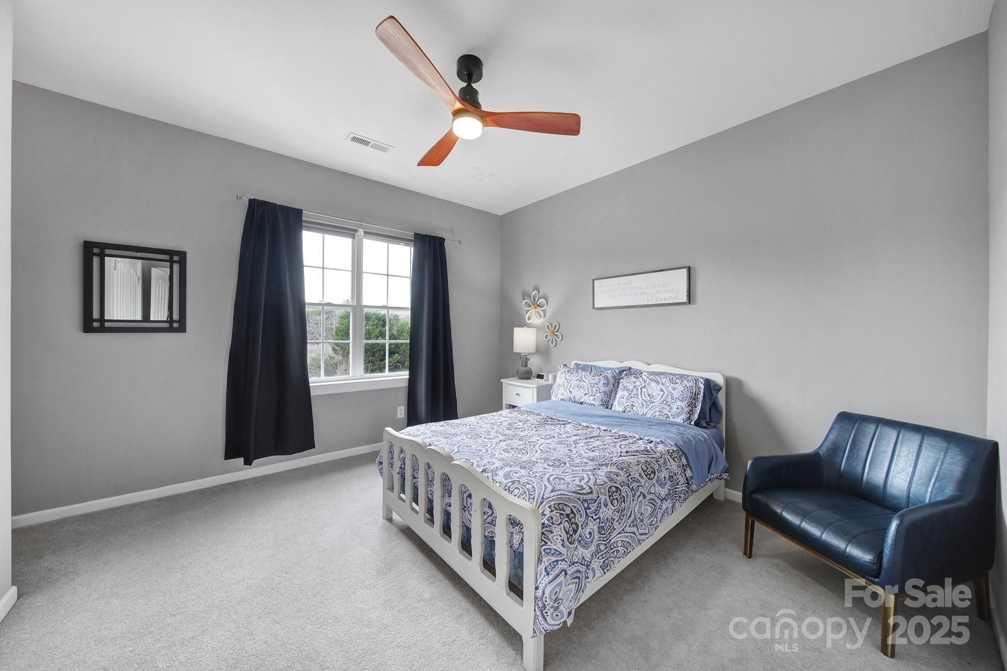 1002 Dataw Lane Indian Trail, NC 28079 - Photo 20 of 36 a bedroom with a bed couch and window