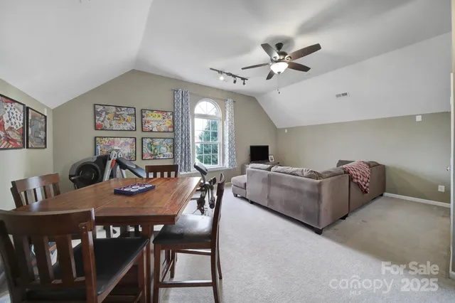 a bedroom with a large bed and a ceiling fan