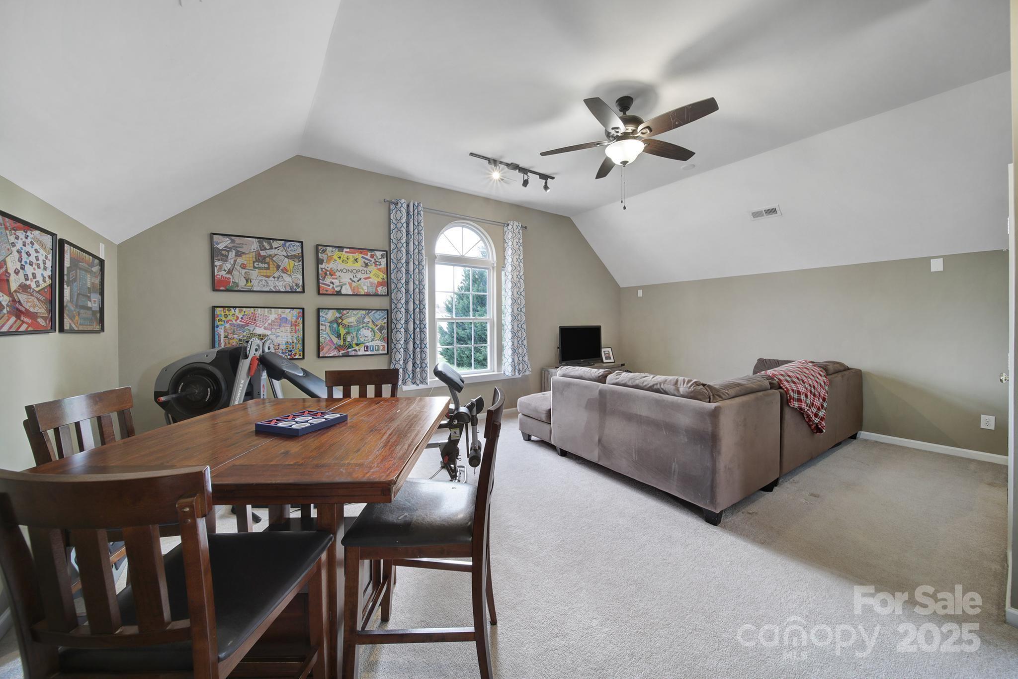 1002 Dataw Lane Indian Trail, NC 28079 - Photo 24 of 36 a living room with furniture a chandelier fan and a large window