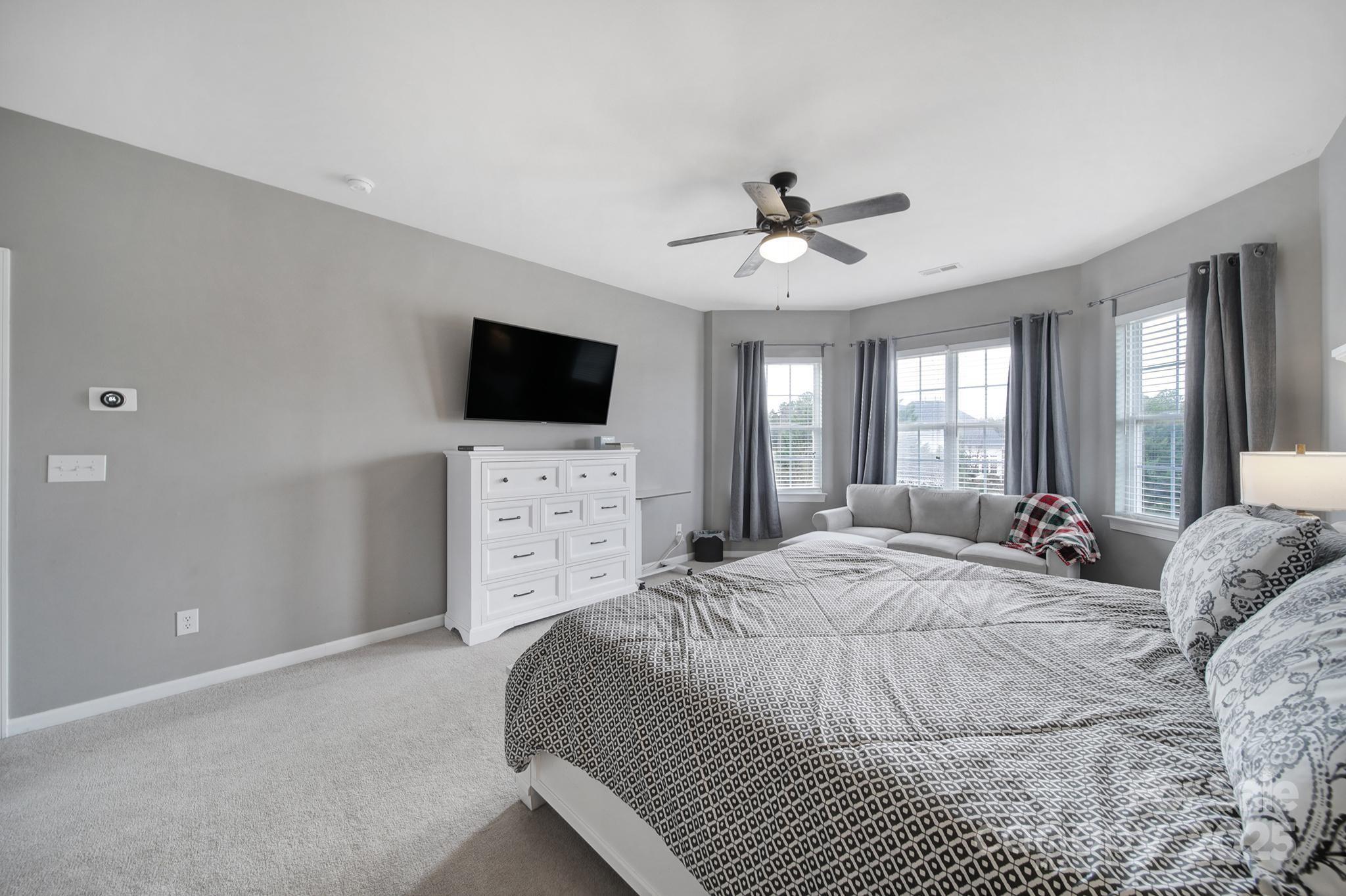 1002 Dataw Lane Indian Trail, NC 28079 - Photo 26 of 36 a spacious bedroom with a bed and a flat screen tv