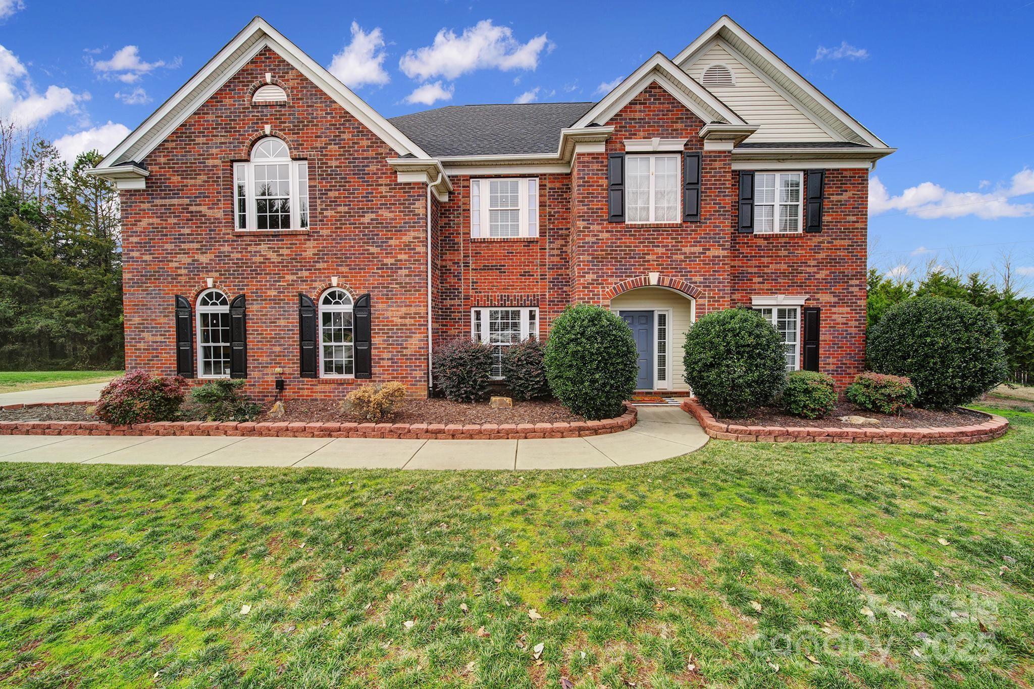 1002 Dataw Lane Indian Trail, NC 28079 - Photo 29 of 36 a front view of a house with a yard and garage