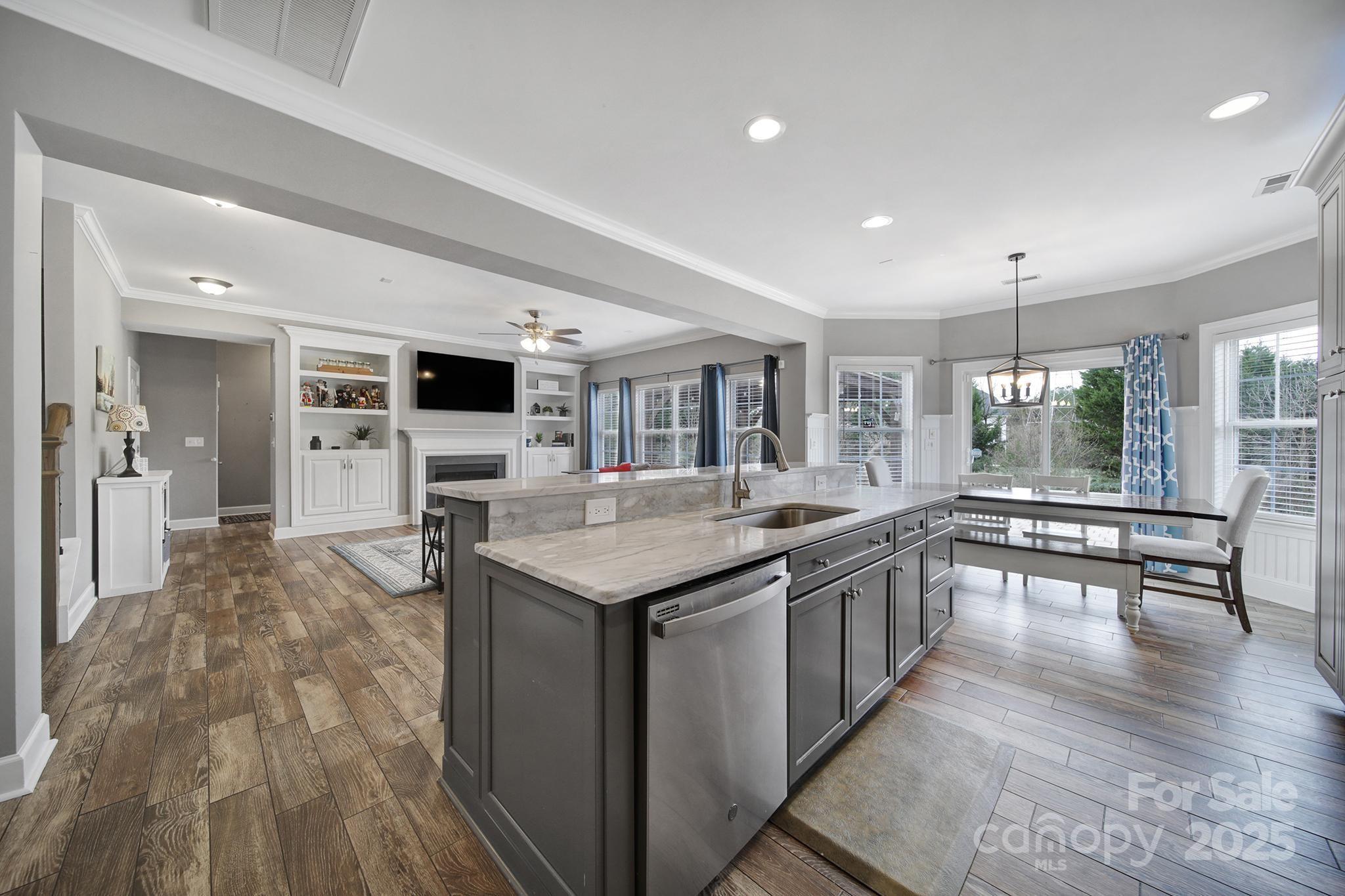 1002 Dataw Lane Indian Trail, NC 28079 - Photo 8 of 36 a kitchen with granite countertop a stove and a wooden floors