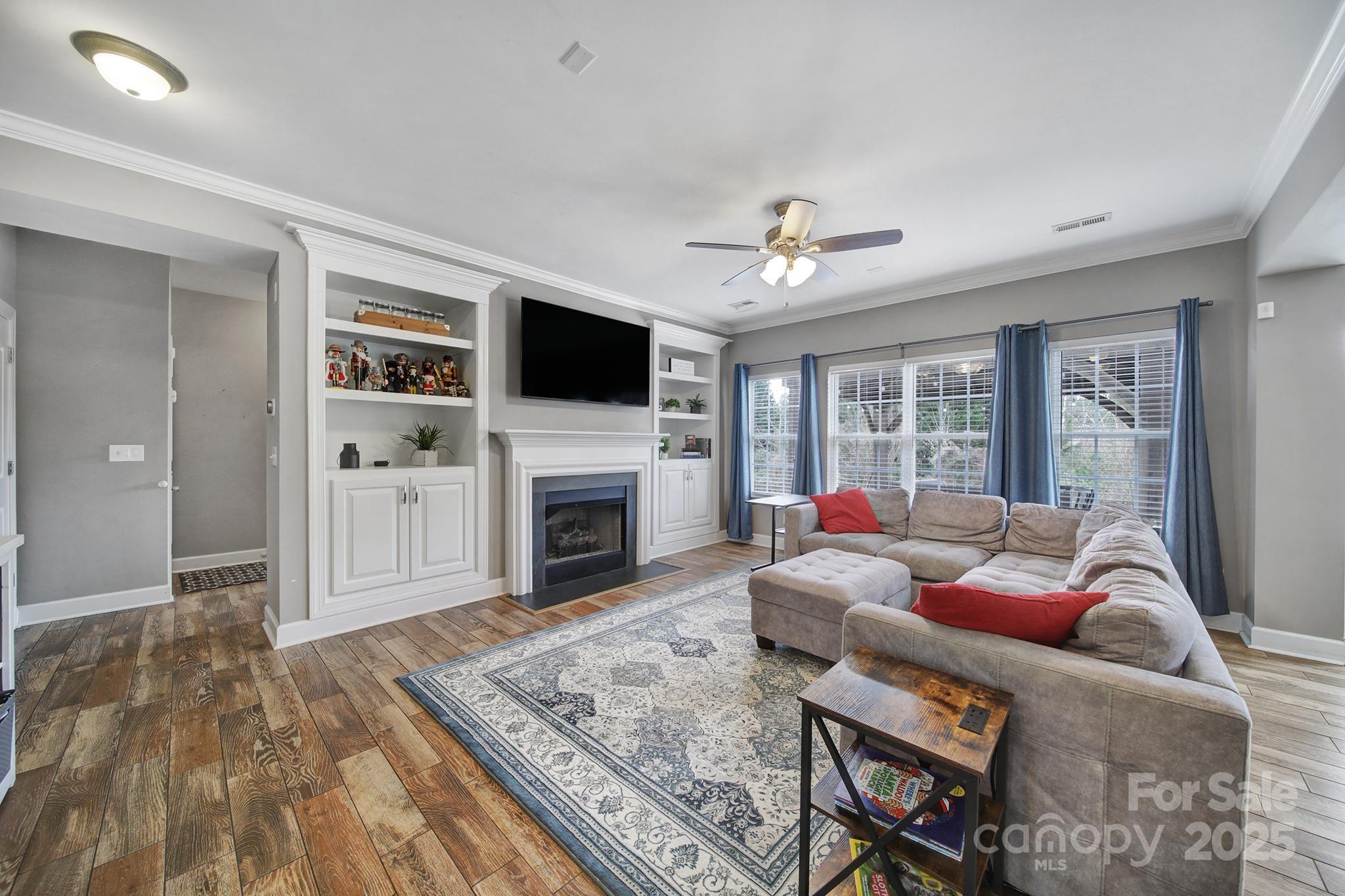1002 Dataw Lane Indian Trail, NC 28079 - Photo 10 of 36 a living room with furniture a fireplace and a flat screen tv