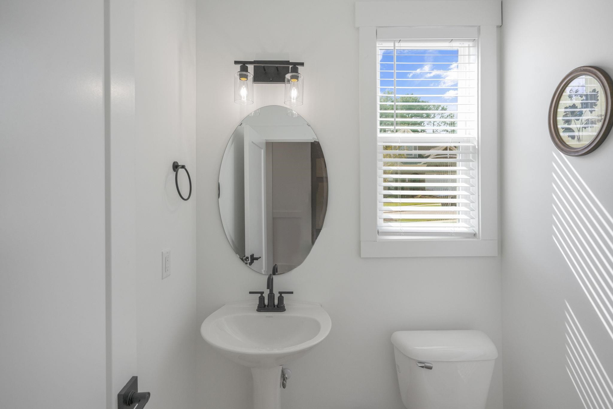 1001 Micato Way Wake Forest, NC 27587 - Photo 19 of 34 a bathroom with a toilet a sink and a mirror