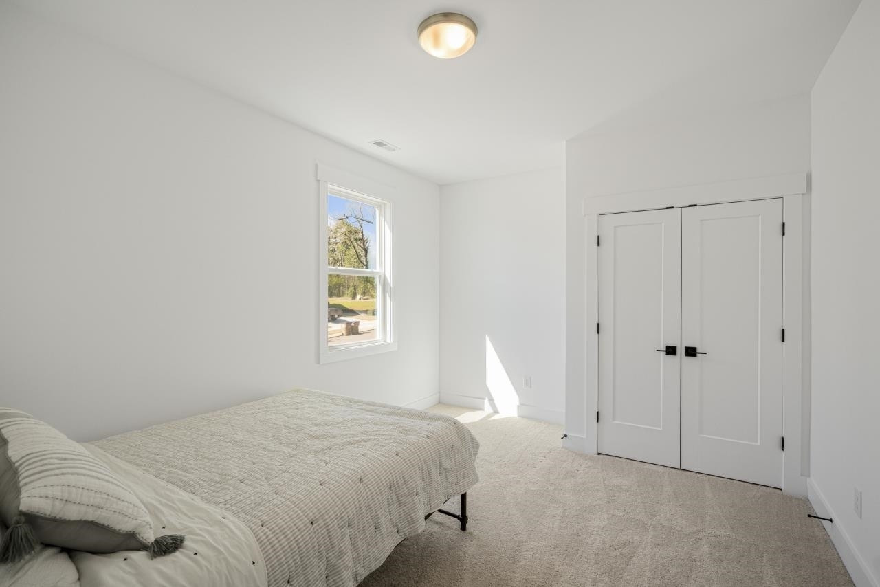 1001 Micato Way Wake Forest, NC 27587 - Photo 30 of 34 a bedroom with a bed and a window