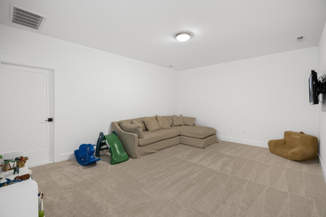 1001 Micato Way Wake Forest, NC 27587 - Photo 31 of 34 a bed room with furniture and a couch