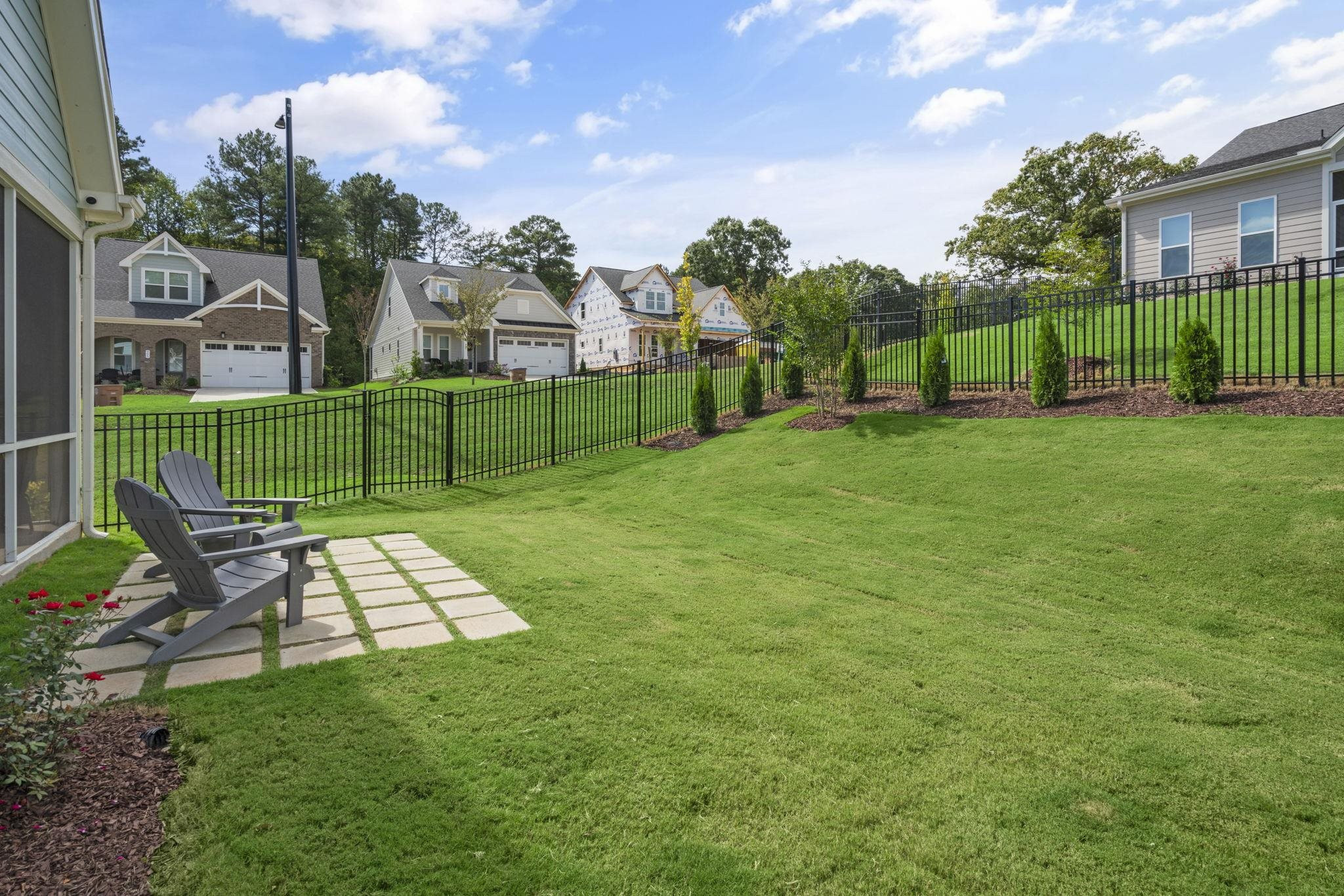 1001 Micato Way Wake Forest, NC 27587 - Photo 32 of 34 a view of a garden with a bench in front of house