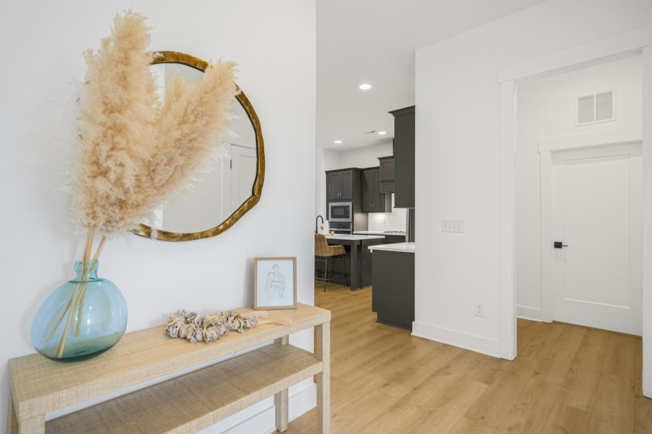 1001 Micato Way Wake Forest, NC 27587 - Photo 5 of 34 a kitchen with stainless steel appliances granite countertop a sink a stove and a wooden floors