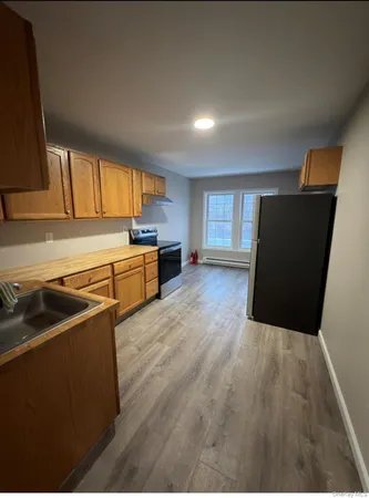 a kitchen with granite countertop a stove and a refrigerator
