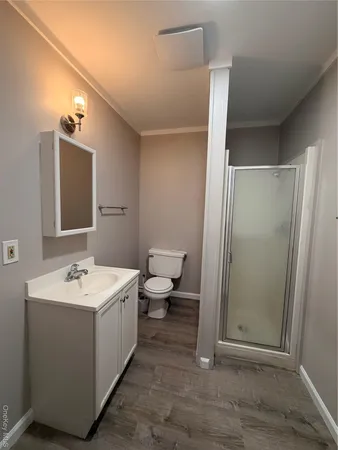 a bathroom with a sink a toilet and shower