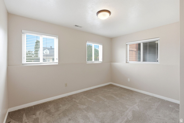 11875 South Elm Ridge Road Sandy, UT 84094 - Photo 26 of 53 Neutral-toned walls complement the light-colored carpet flooring