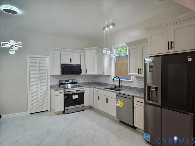 a kitchen with stainless steel appliances granite countertop a refrigerator stove a sink and dishwasher
