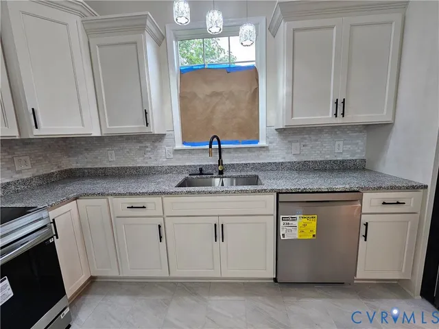 a kitchen with stainless steel appliances granite countertop a sink stove and cabinets