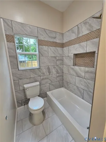 a white toilet sitting next to a bath tub