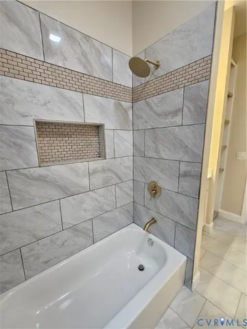 a bathroom with a bathtub and shower