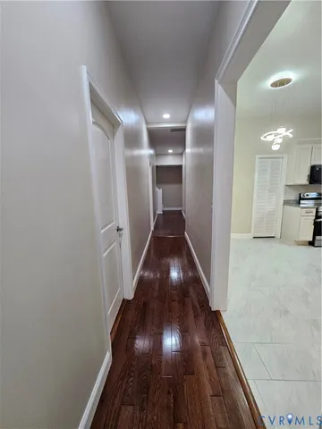 an empty room with a window and ceiling fan