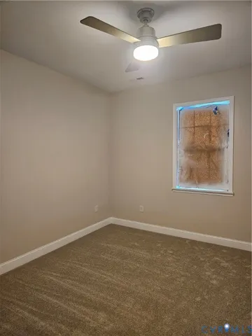 an empty room with closet and fan