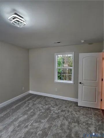 a view of staircase with wooden floor and fan