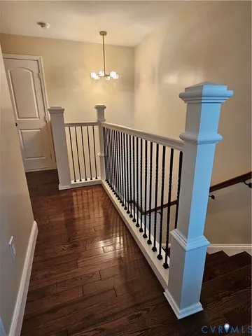 a view of a room with wooden floor windows and a chandelier