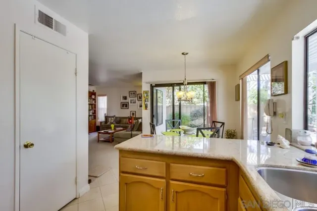 a view of a kitchen with kitchen island a sink and living room view