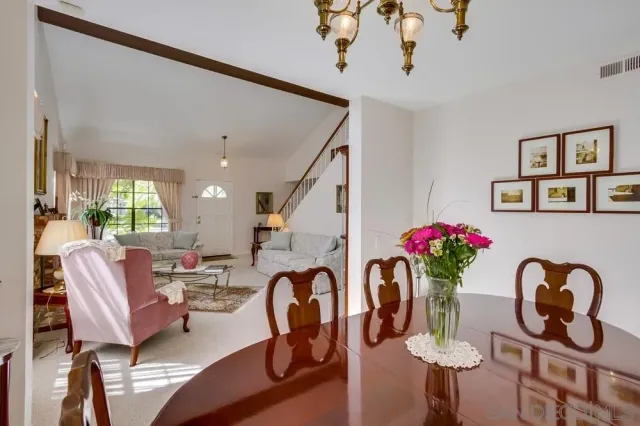 a dining room with furniture and wooden floor