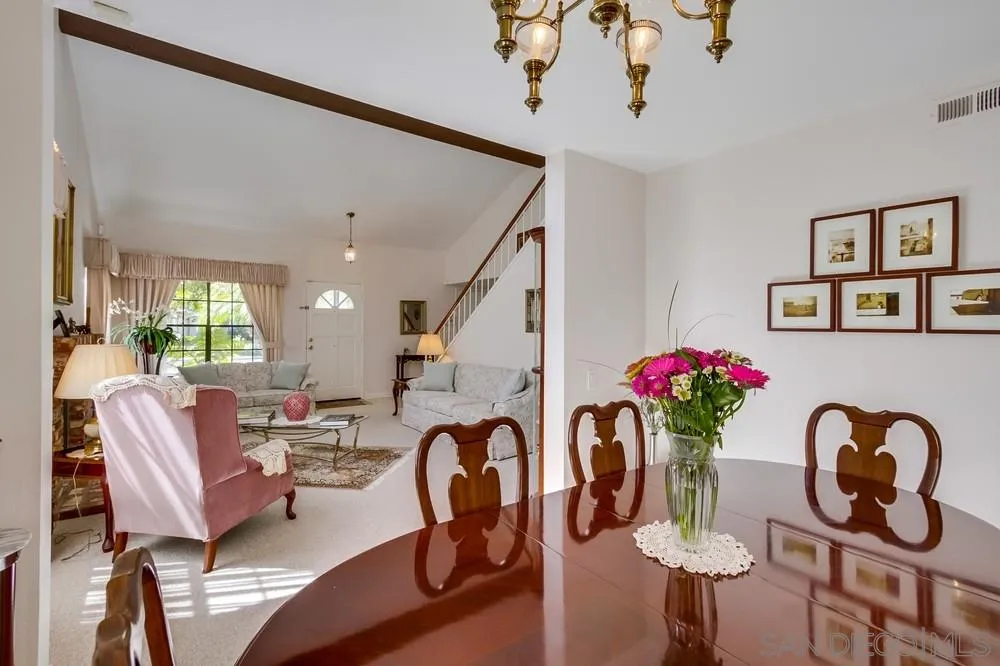 13354 Benchley Road San Diego, CA 92130 - Photo 3 of 24 a dining room with furniture and wooden floor